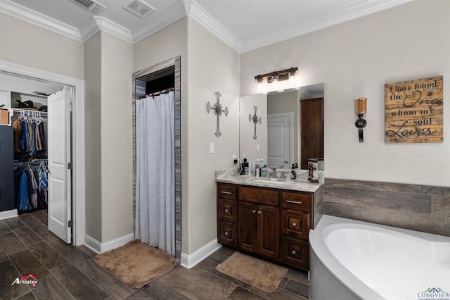 bathroom featuring vanity, a tub to relax in, and crown molding