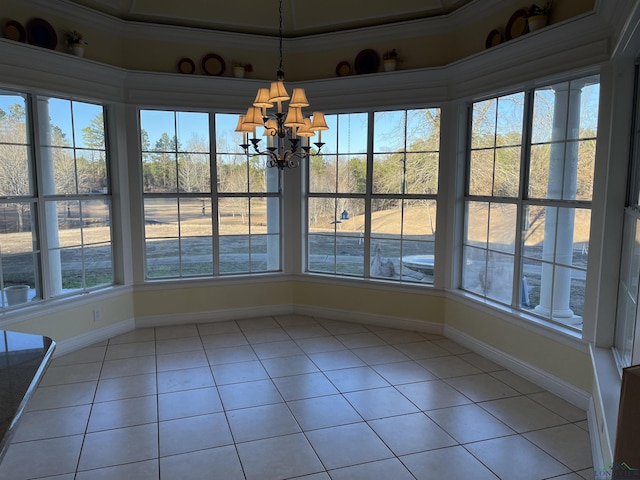 unfurnished dining area featuring an inviting chandelier, tile patterned floors, and crown molding