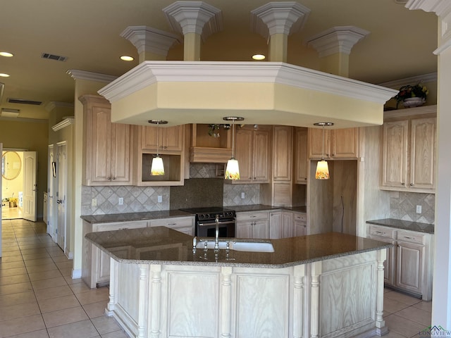 kitchen with light brown cabinets, backsplash, pendant lighting, electric stove, and light tile patterned floors