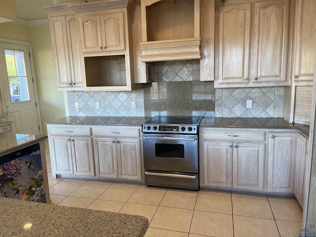 kitchen with stainless steel electric stove, light stone counters, light tile patterned floors, and premium range hood