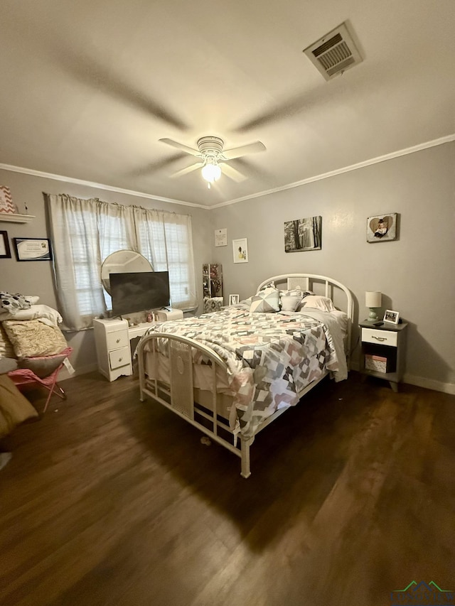bedroom with baseboards, ornamental molding, dark wood finished floors, and visible vents