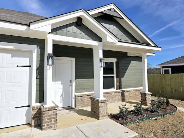 entrance to property with a garage and a porch