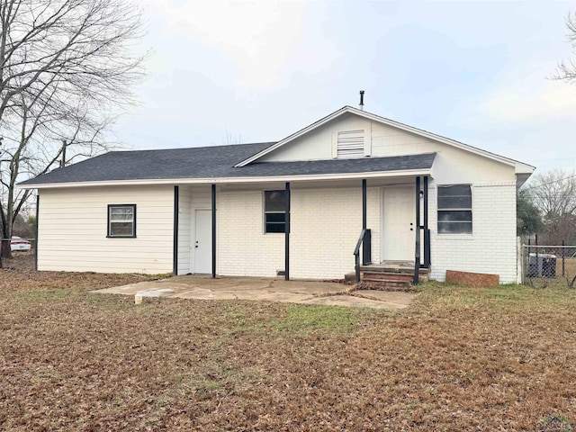 back of property featuring a yard and a patio