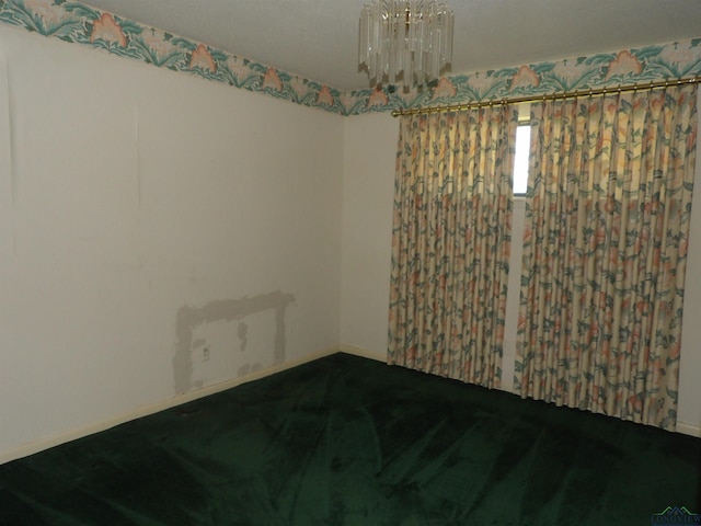 spare room with a chandelier