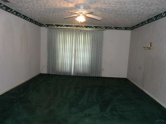 unfurnished room with ceiling fan, carpet floors, and a textured ceiling