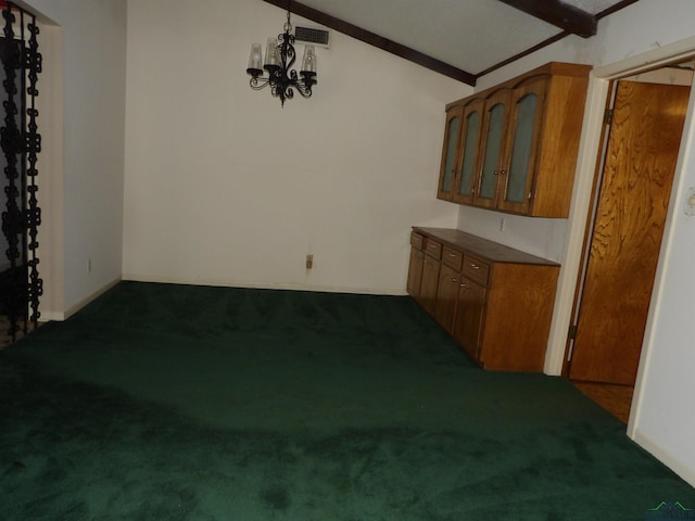 interior space featuring dark carpet, lofted ceiling, and a chandelier