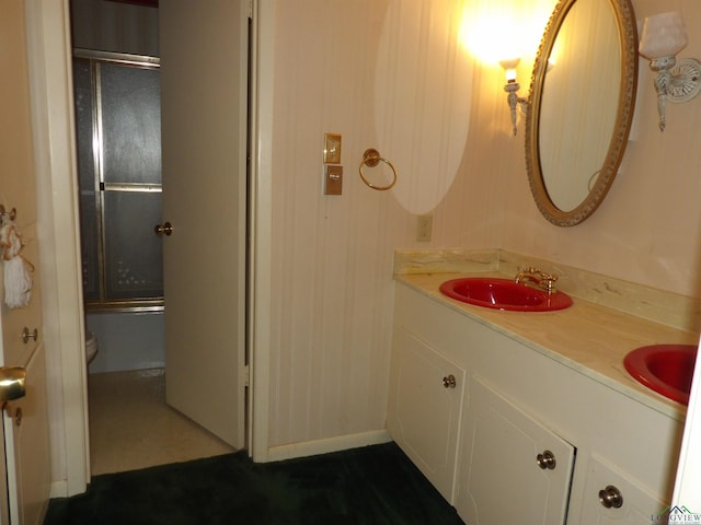 2307 Lilly St, Longview, TX 75602 - bathroom featuring double vanity and bath / shower combo with glass door