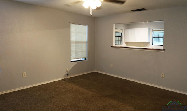 2104 Ark St, Marshall, TX 75670 - unfurnished room featuring a ceiling fan and dark colored carpet