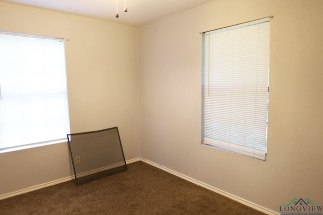 2104 Ark St, Marshall, TX 75670 - unfurnished room featuring dark carpet and baseboards