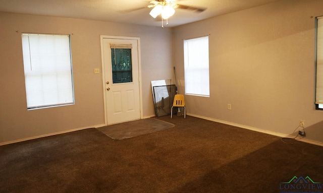 2104 Ark St, Marshall, TX 75670 - unfurnished room featuring a ceiling fan and dark carpet