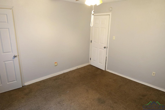 2104 Ark St, Marshall, TX 75670 - empty room featuring dark carpet and ceiling fan