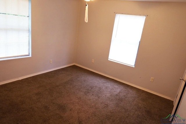 2104 Ark St, Marshall, TX 75670 - spare room with dark colored carpet and plenty of natural light