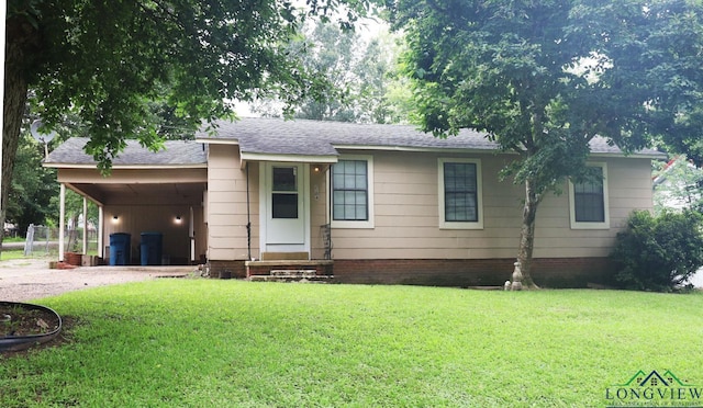 2104 Ark St, Marshall, TX 75670 - view of front of house with a front lawn, an attached carport, driveway, and a shingled roof