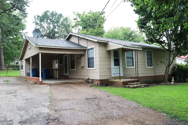 2104 Ark St, Marshall, TX 75670 - ranch-style house featuring driveway, roof with shingles, and a carport