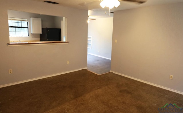 2104 Ark St, Marshall, TX 75670 - empty room with dark carpet and ceiling fan