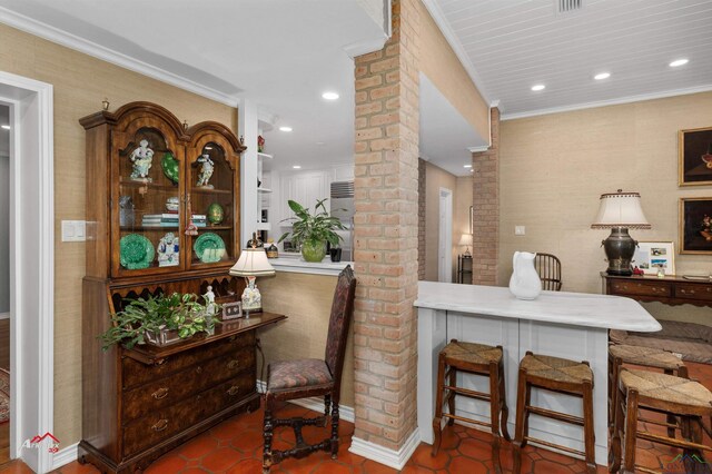 interior space with tile patterned floors, ornamental molding, and decorative columns