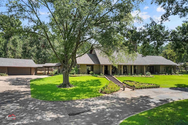 single story home featuring a front yard and a garage