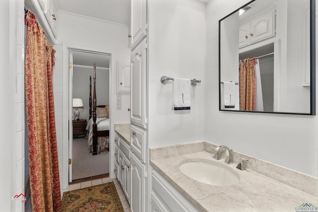 bathroom with vanity, tile patterned floors, and ornamental molding