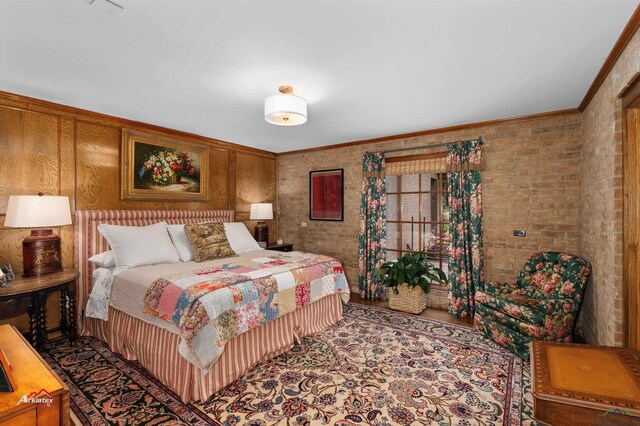 bedroom with crown molding and brick wall