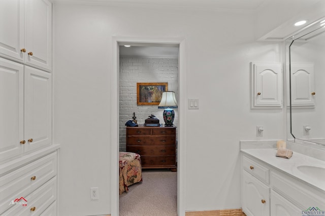 bathroom featuring vanity and ornamental molding