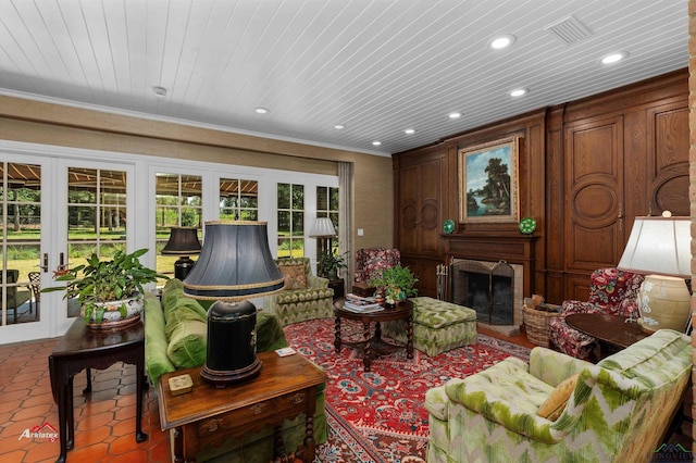 tiled living room featuring french doors, wooden ceiling, and ornamental molding