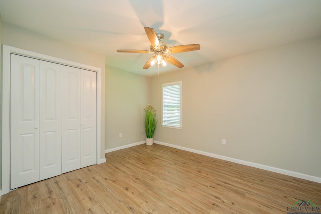 1021 N Montgomery St, Gilmer, TX 75644 - unfurnished bedroom with light wood-style flooring, a closet, and a ceiling fan