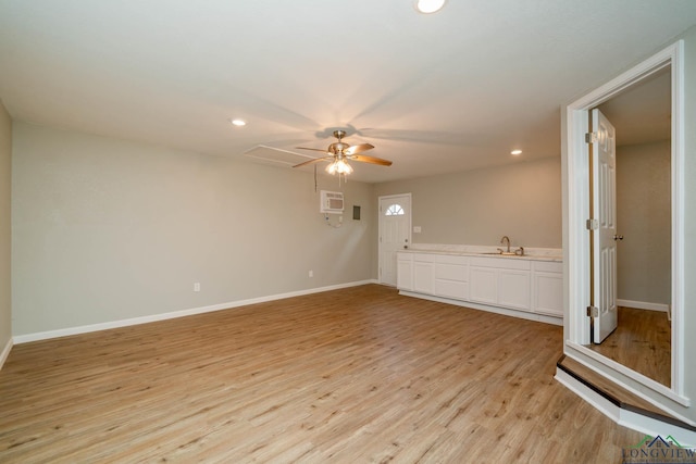 1021 N Montgomery St, Gilmer, TX 75644 - spare room featuring light wood finished floors, ceiling fan, a wall mounted air conditioner, and recessed lighting
