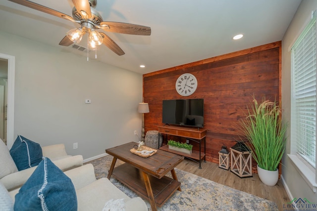 1021 N Montgomery St, Gilmer, TX 75644 - living room with a ceiling fan, recessed lighting, wood walls, and wood finished floors