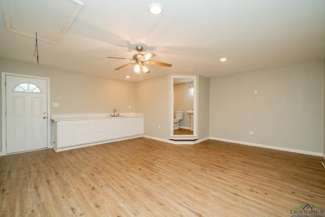 1021 N Montgomery St, Gilmer, TX 75644 - unfurnished living room with attic access, light wood-style flooring, ceiling fan, and recessed lighting