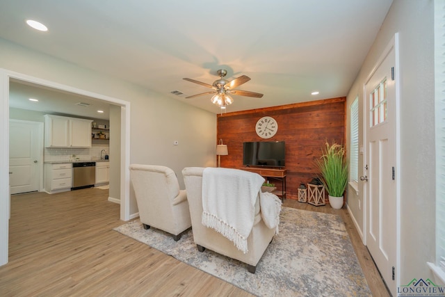 1021 N Montgomery St, Gilmer, TX 75644 - living area featuring wood walls, light wood-style flooring, a ceiling fan, and recessed lighting