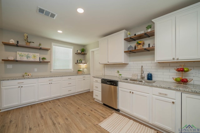 1021 N Montgomery St, Gilmer, TX 75644 - kitchen featuring open shelves, stainless steel dishwasher, white cabinetry, light wood-style flooring, and recessed lighting