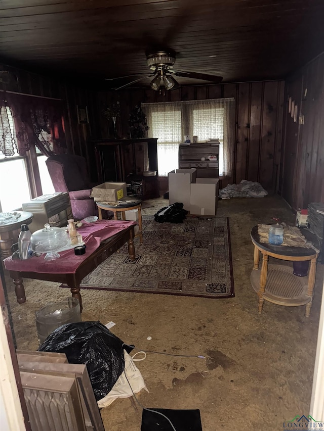 miscellaneous room featuring ceiling fan and wooden walls