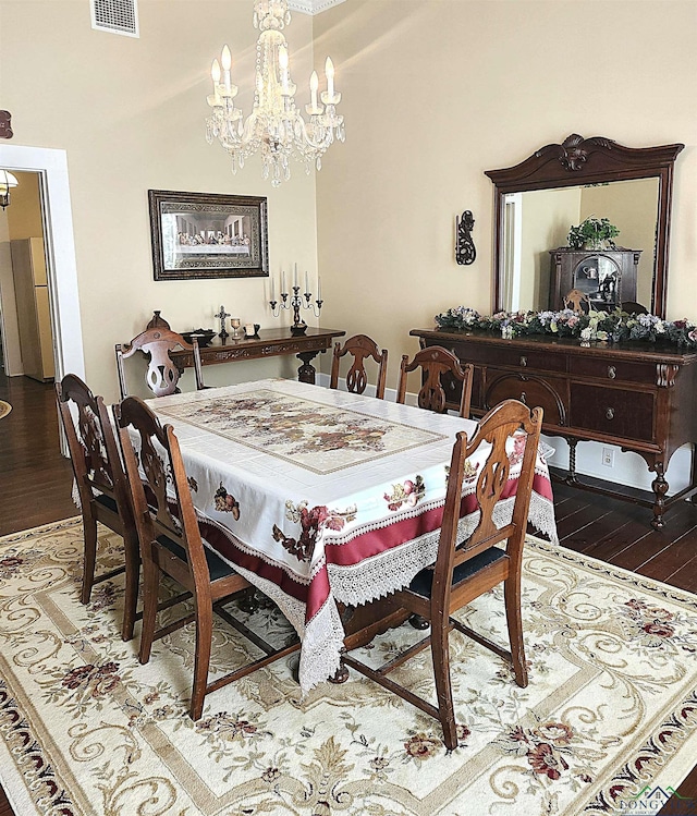 dining space featuring hardwood / wood-style floors and a notable chandelier