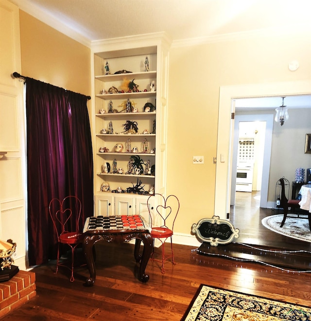 dining space with dark hardwood / wood-style flooring, built in features, and a chandelier