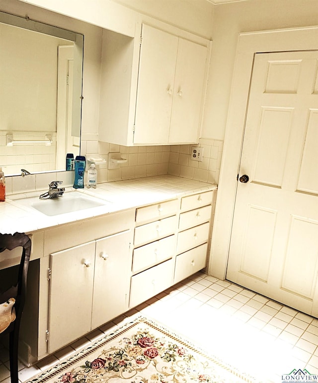 bathroom featuring decorative backsplash, vanity, and tile patterned floors