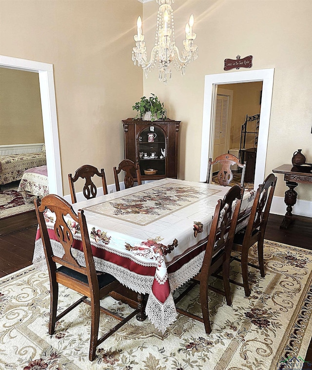 dining area featuring hardwood / wood-style flooring and a notable chandelier