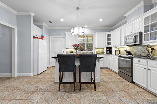5201 Whitaker, Longview, TX 75605 - kitchen featuring appliances with stainless steel finishes, dark countertops, backsplash, white cabinets, and ornamental molding