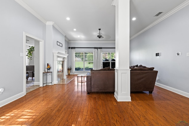 5201 Whitaker, Longview, TX 75605 - living area featuring decorative columns, wood finished floors, crown molding, a fireplace, and recessed lighting