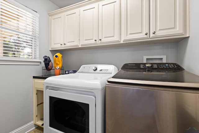 5201 Whitaker, Longview, TX 75605 - laundry room featuring washing machine and clothes dryer and cabinet space