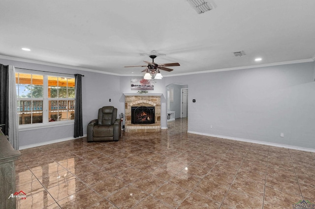 unfurnished living room with crown molding, a fireplace, and ceiling fan