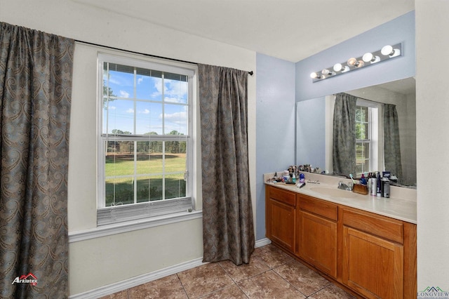 bathroom with tile patterned flooring, vanity, and a wealth of natural light