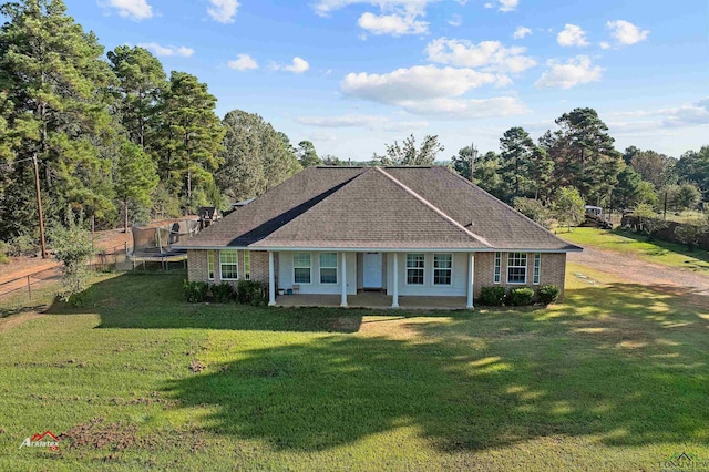 single story home featuring a patio area, a trampoline, and a front lawn