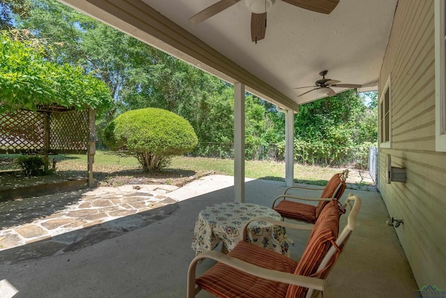 view of patio featuring fence and a ceiling fan