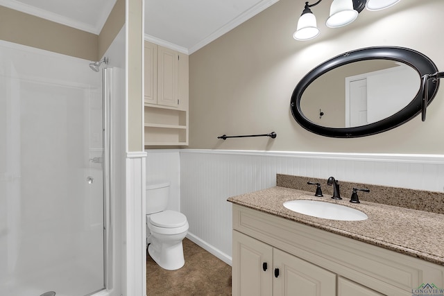 full bath with vanity, toilet, a stall shower, and wainscoting