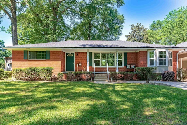 ranch-style house with covered porch, a front lawn, and brick siding