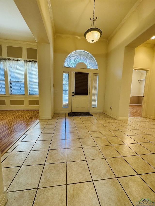 tiled entrance foyer featuring ornamental molding