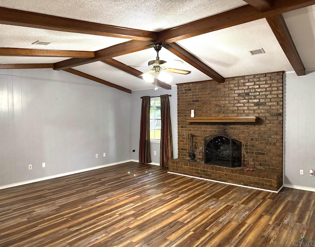909 Stewart St, Atlanta, TX 75551 - unfurnished living room with wood finished floors, a brick fireplace, ceiling fan, a textured ceiling, and wooden walls