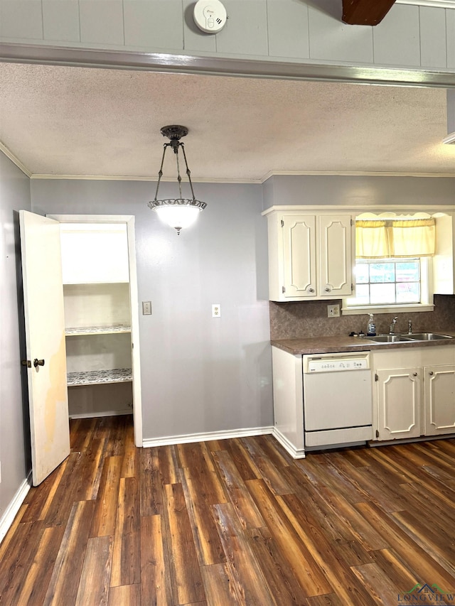 909 Stewart St, Atlanta, TX 75551 - kitchen with white dishwasher, crown molding, a textured ceiling, white cabinetry, and dark countertops