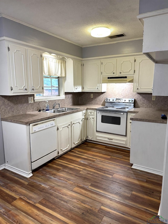 909 Stewart St, Atlanta, TX 75551 - kitchen with white appliances, under cabinet range hood, ornamental molding, dark countertops, and backsplash