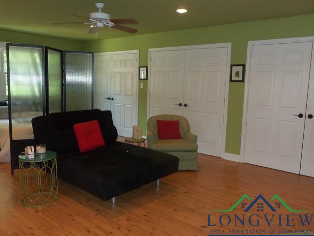 living room featuring ceiling fan and light hardwood / wood-style floors